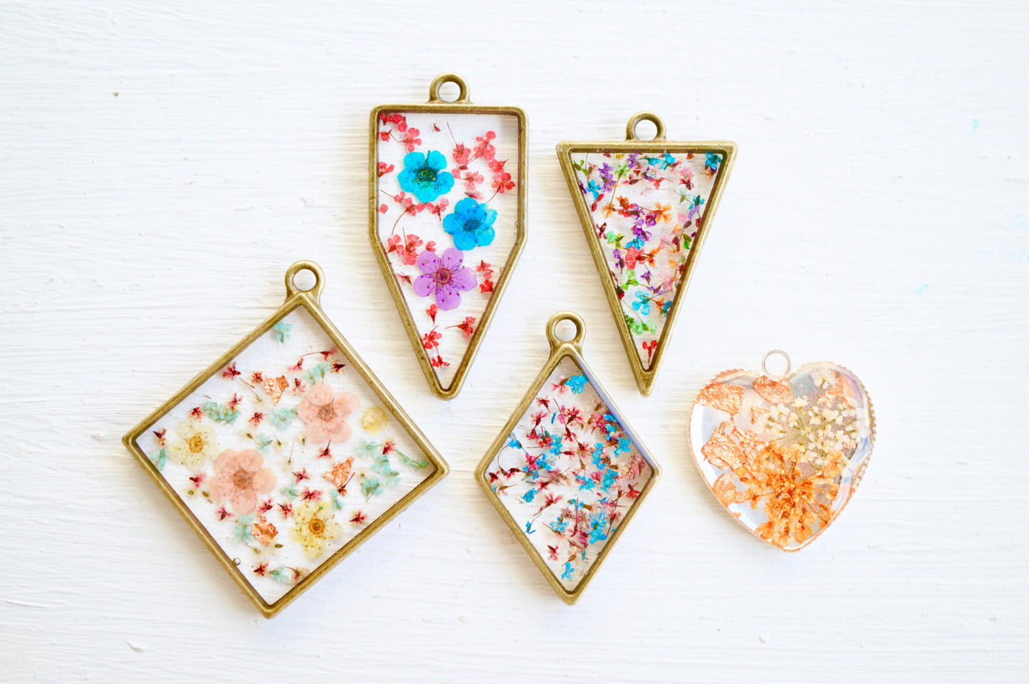 Real Pressed Flower and Resin Moon Necklace in Blues, Pinks, and Whites.