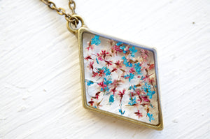 Real Pressed Flower and Resin Moon Necklace in Blues, Pinks, and Whites.