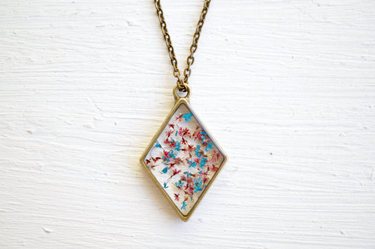 Real Pressed Flower and Resin Moon Necklace in Blues, Pinks, and Whites.